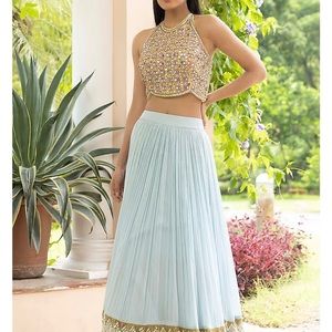 Ice blue lehenga with pearl details and matching embroidered top and scarf.